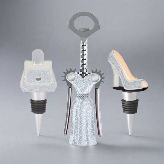 Three unique bottle stoppers shaped like a handbag, dress, and high heel on a gray background.
