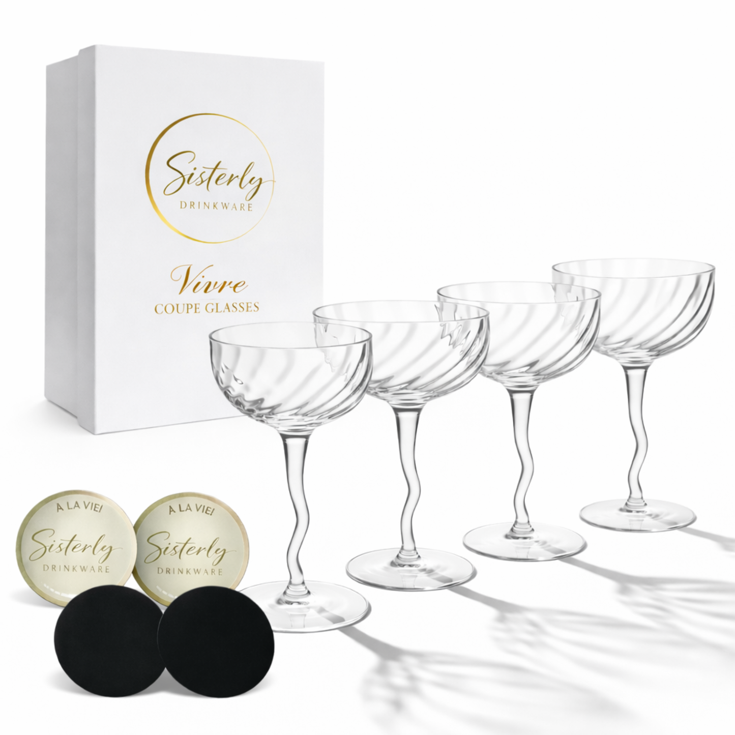 Set of four clear vivre coupe glasses with a 'Sisterly Drinkware' branded box on a white background