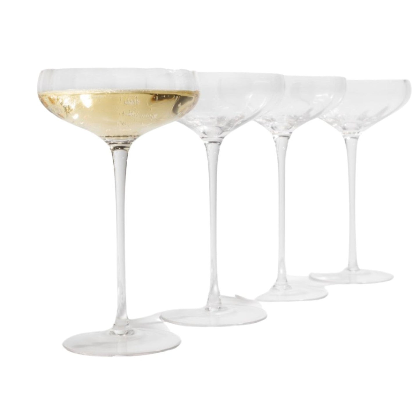 Set of four champagne coupe glasses with one filled with champagne on a white background