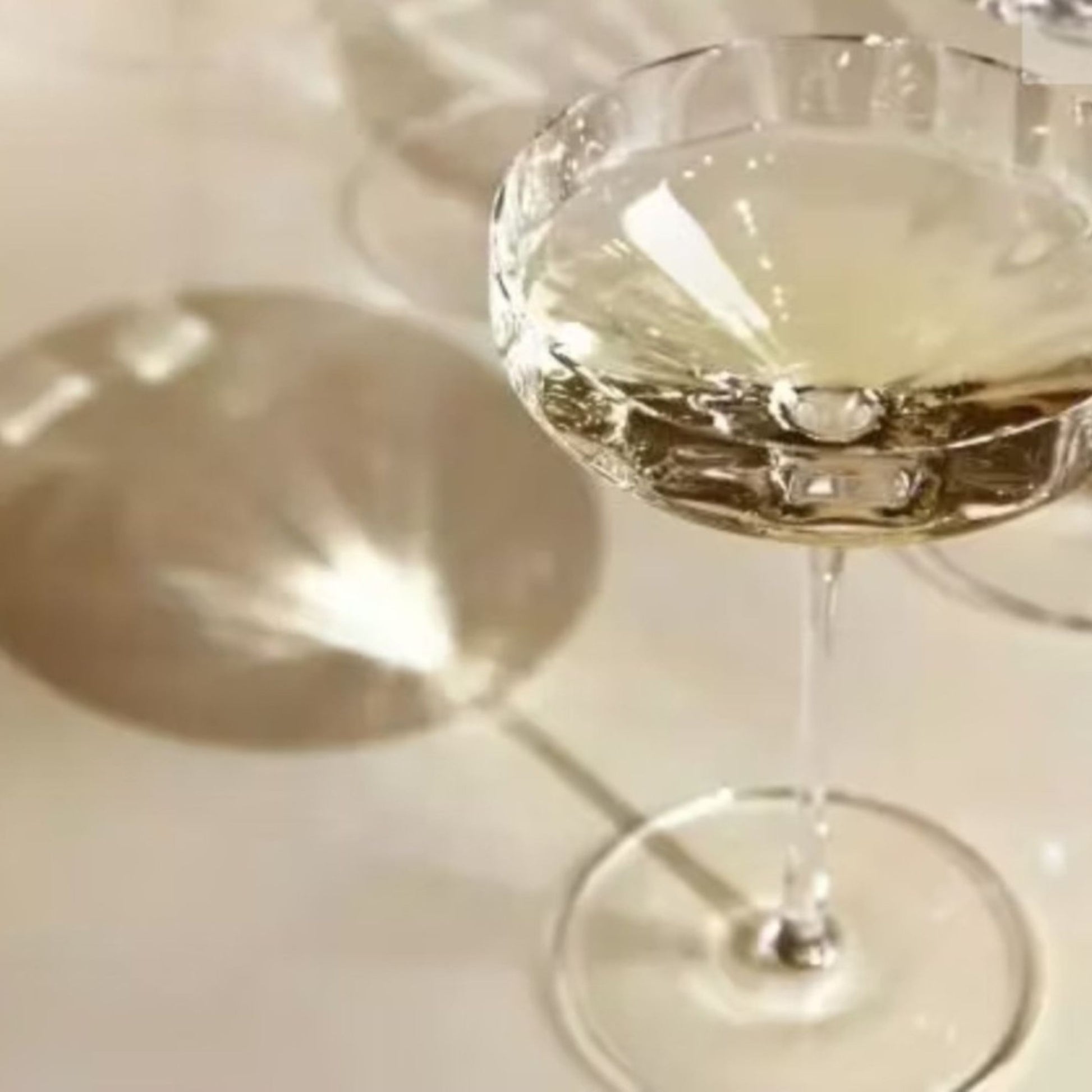 Glass of white wine on a white surface