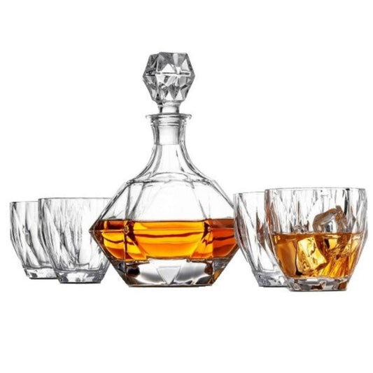 Clear glass decanter with whiskey and two glasses on a white background