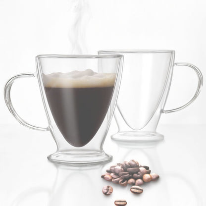 Two clear glass mugs with handles, one filled with coffee and the other empty, on a white background with scattered coffee beans.