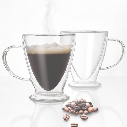 Two clear glass mugs with handles, one filled with coffee and the other empty, on a white background with scattered coffee beans.