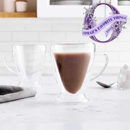 Clear glass mug with hot chocolate on a white surface, featuring Oprah's Favorite Things 2023 logo.