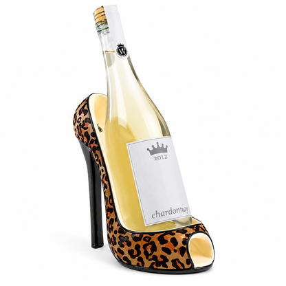 A novelty wine bottle shaped like a high-heeled shoe, filled with white wine. The shoe design features a leopard print pattern in brown, black, and beige, with a black stiletto heel and a white label that reads 'chardonnay' and '2012'.