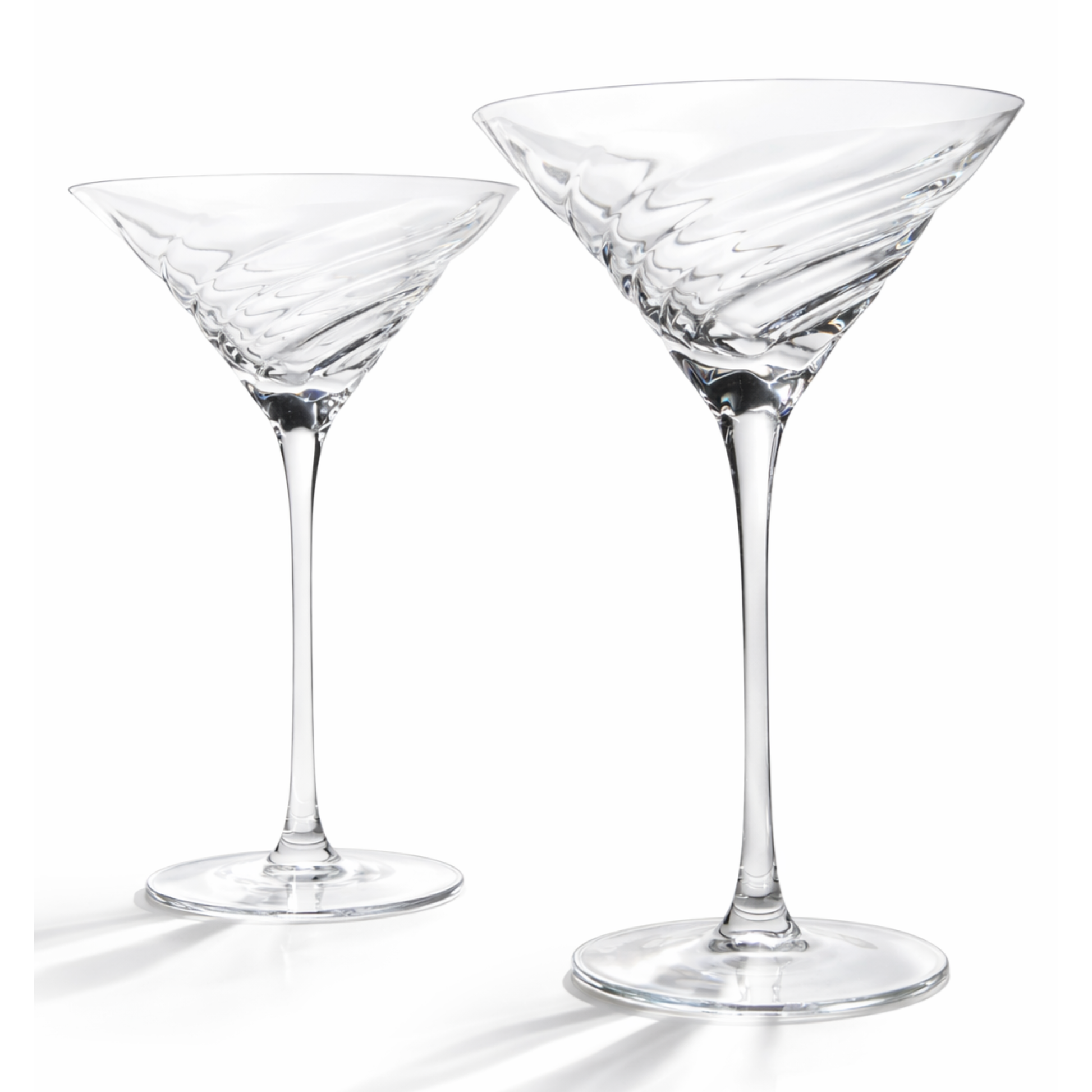 Two clear martini glasses on a white background