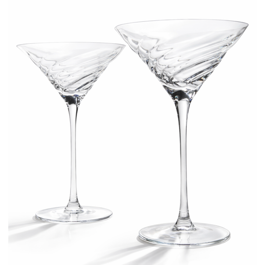 Two clear martini glasses on a white background