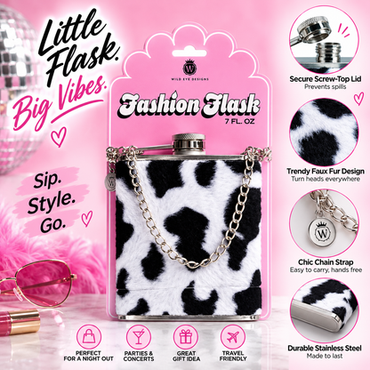 A pink retail package for a small flask-shaped bottle with a black-and-white faux fur body and silver chain strap. The package includes marketing text, feature callouts, and decorative props on a pink background.